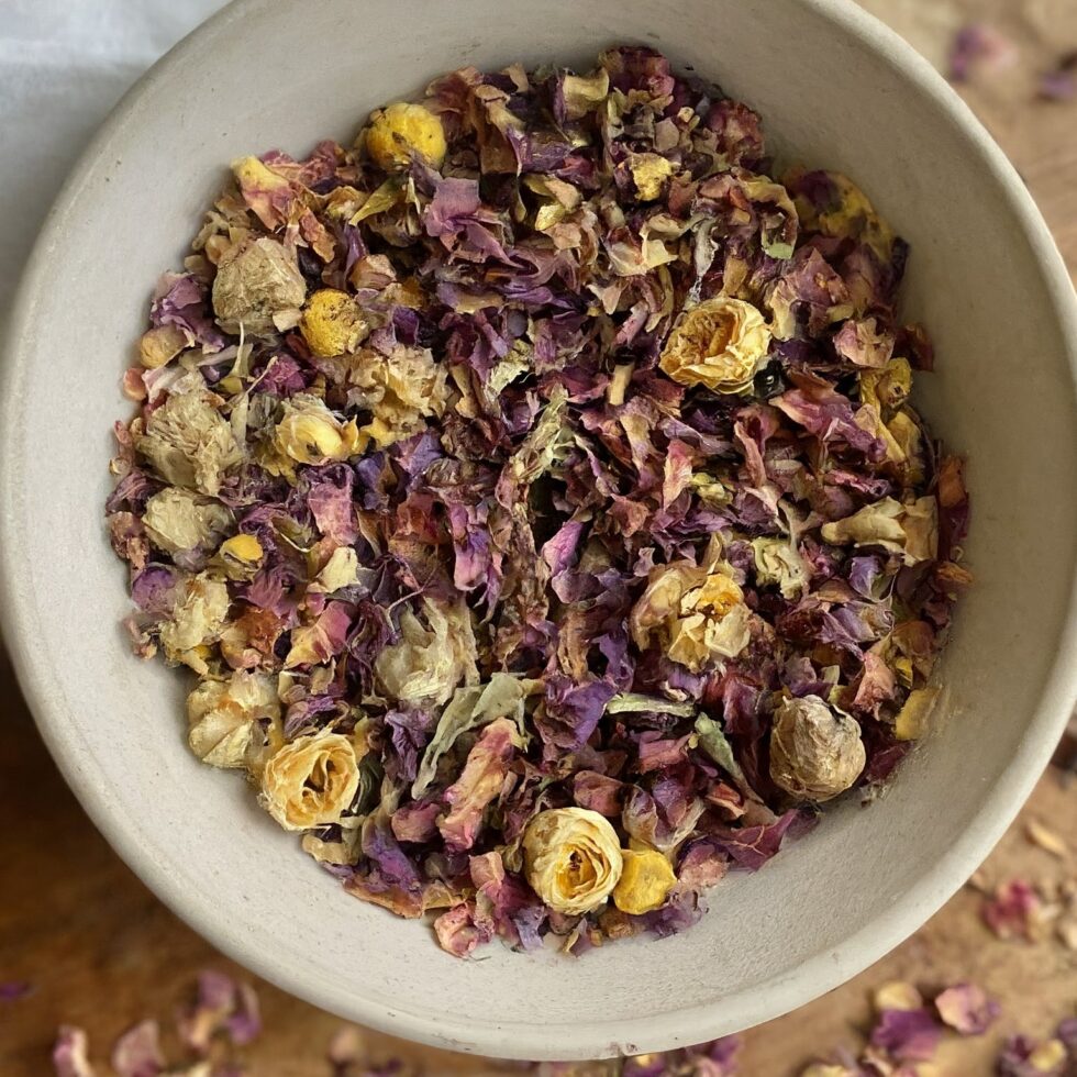 Bowl of dried flowers and herbs used as a natural sleep aid or calming herbal tea blend.